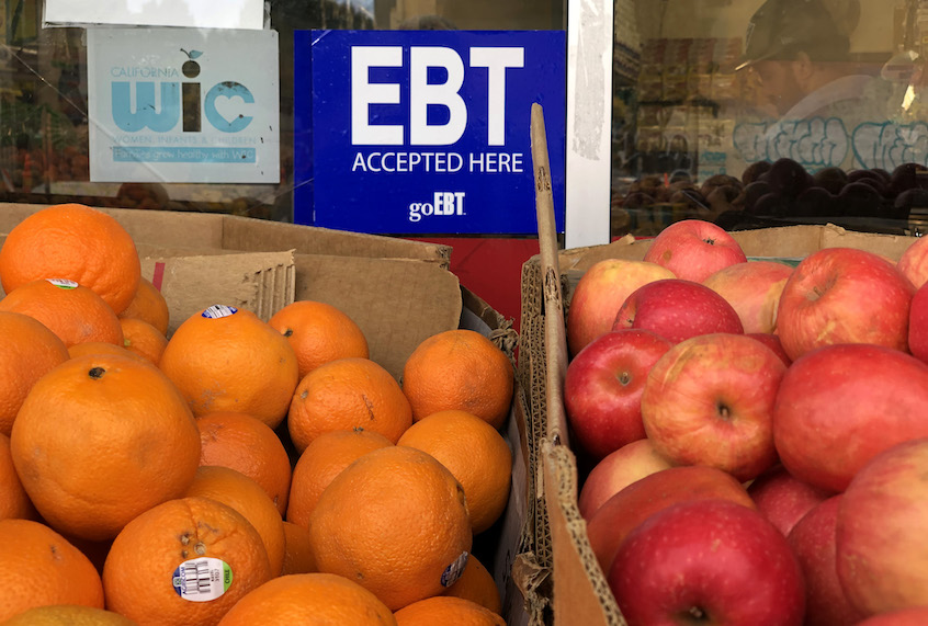 A sign noting the acceptance of electronic benefit transfer (EBT) cards that are used by state welfare departments to issue benefits is displayed at a grocery store on December 04, 2019 in Oakland, California. (Justin Sullivan/Getty Images)
